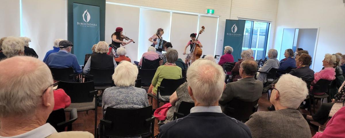 An audience watching the 3 Stilleto Sisters performing