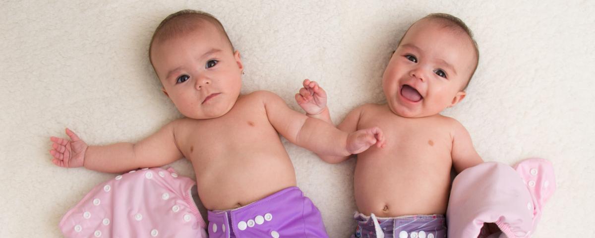 Two babies in reusable nappies