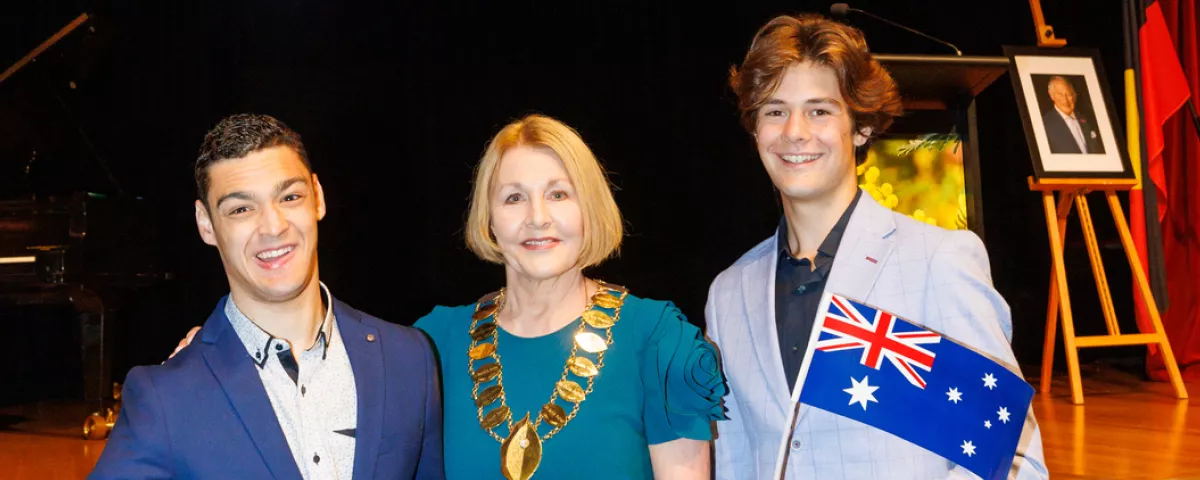 Citizen of the Year Brenton Ponza in dark-blue jacket, Mayor Lisa Hollingsworth in green dress, and Young Citizen of the Year Henry Shireffs in light-blue jacket.