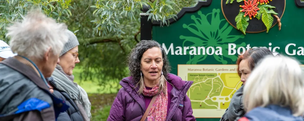 Group of people gathered around Maranoa Gardens signpost
