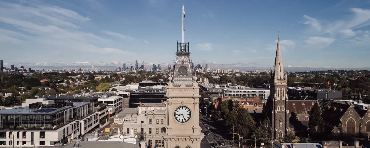 Hawthorn Arts Centre clock tower from above. The Melbourne City skyline is on the horizon