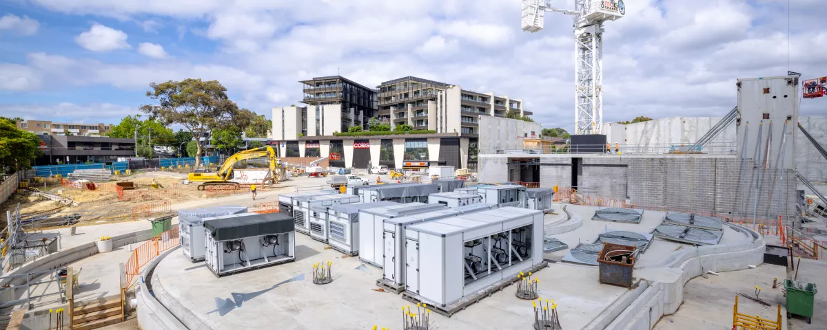 A construction zone with a large cement slab and prefab buildings