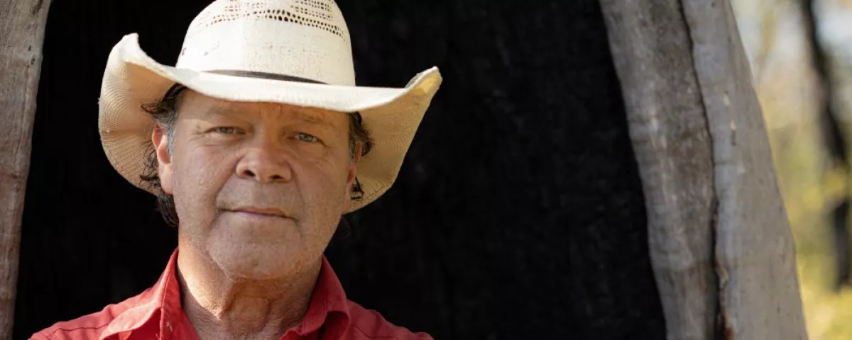 Man in a cowboy hat smiling