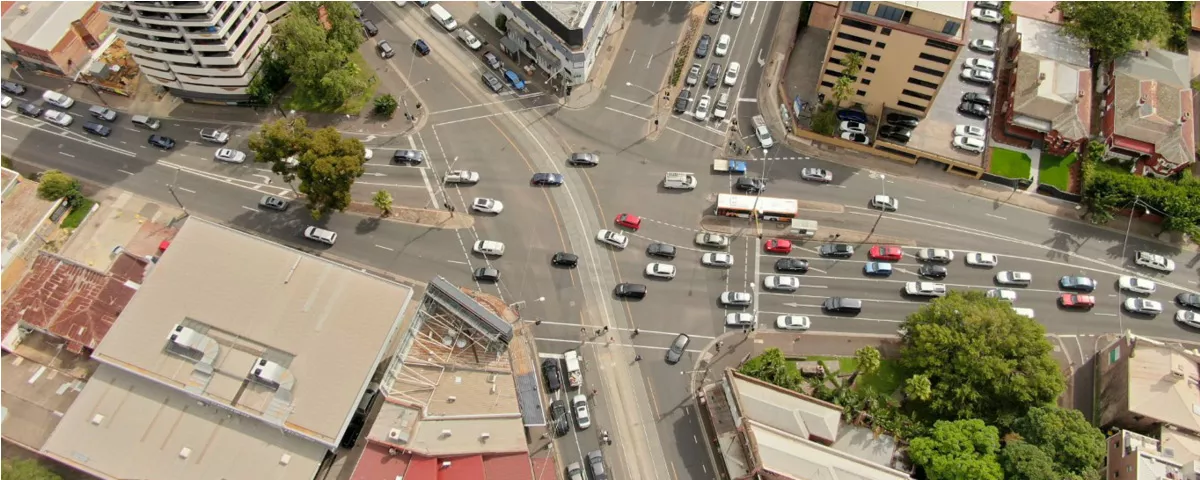 Aerial photo shows busy junction with buildings and traffic 