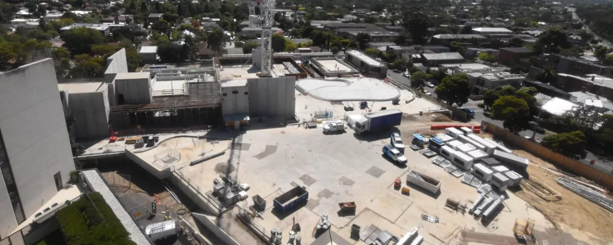 Work site with building materials, structures and vehicles