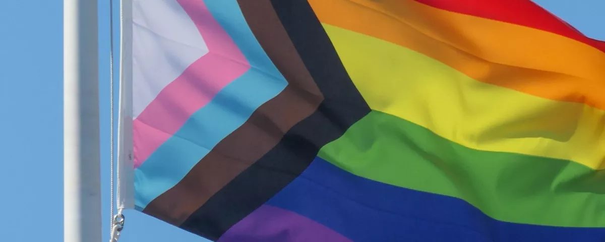 A billowing rainbow Pride flag