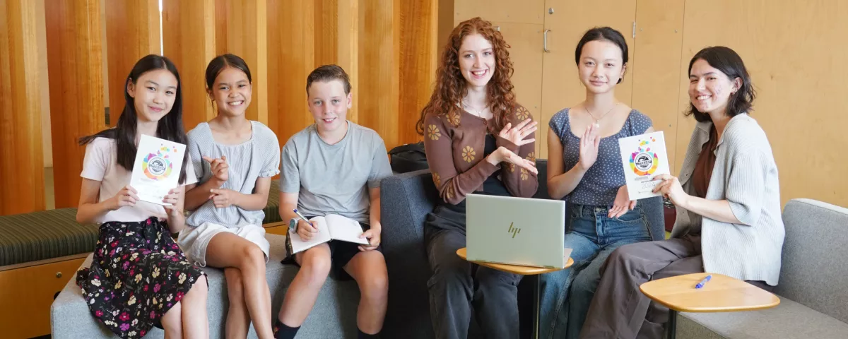 Six Literary Awards winners sit and show off their awards.