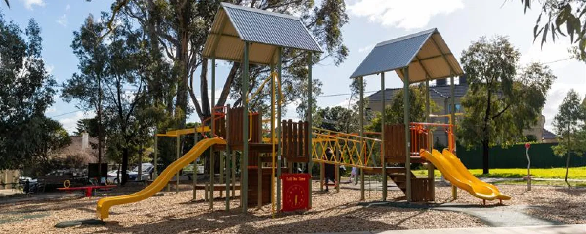 A playground with a climbing structure and slides