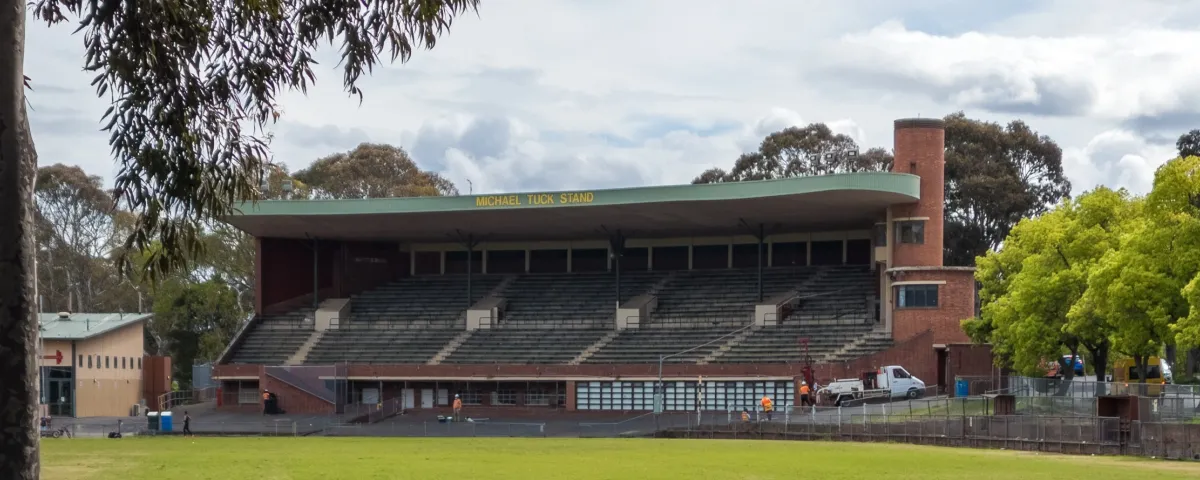 A heritage sports grandstand with signage saying Michael Tuck Stand.