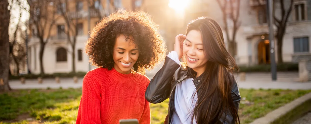 Two people looking at mobile phone