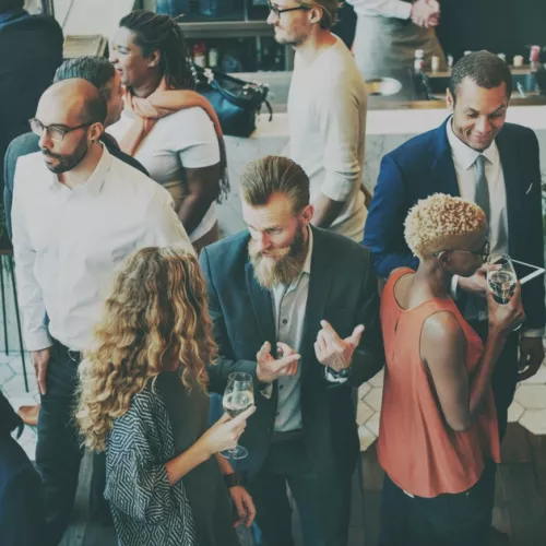 A busy room filled with people talking to each other