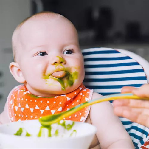  Baby in a high chair being fed