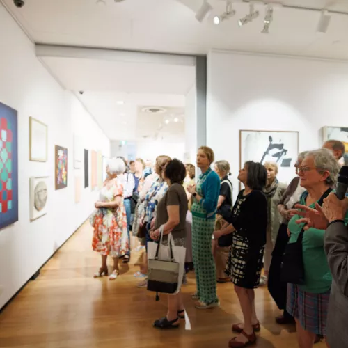 Group of people viewing art in gallery 