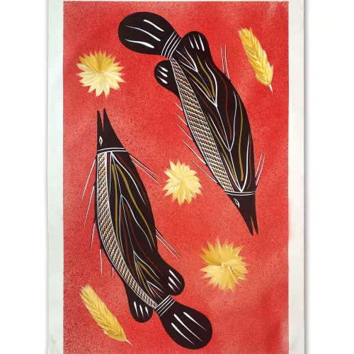 Two barramundi fish are swimming in opposite directions, the water around them is red. There are yellow flowers and feathers floating in between and around them. 
