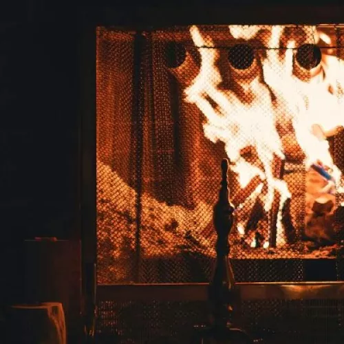 An open fireplace with wood logs burning