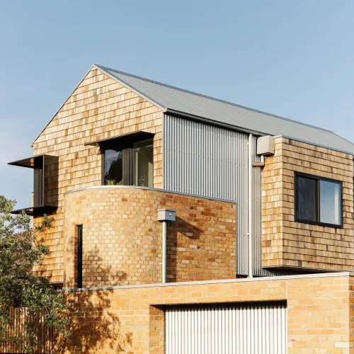 A brick home with some steel cladding