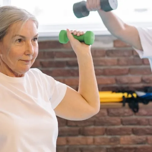 two people doing an exercise class with dumbbells