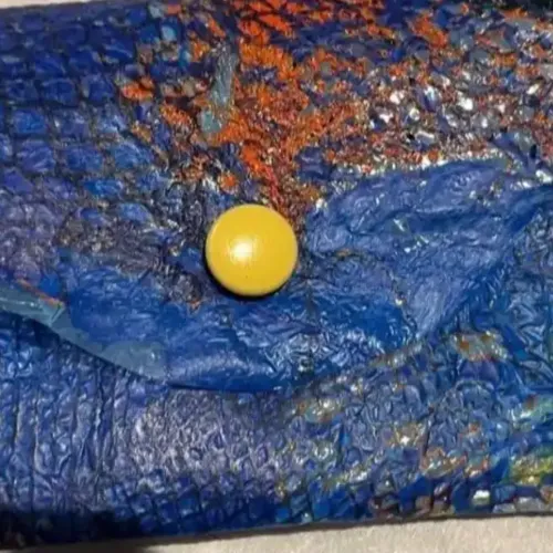 A small blue coin purse made of soft plastic