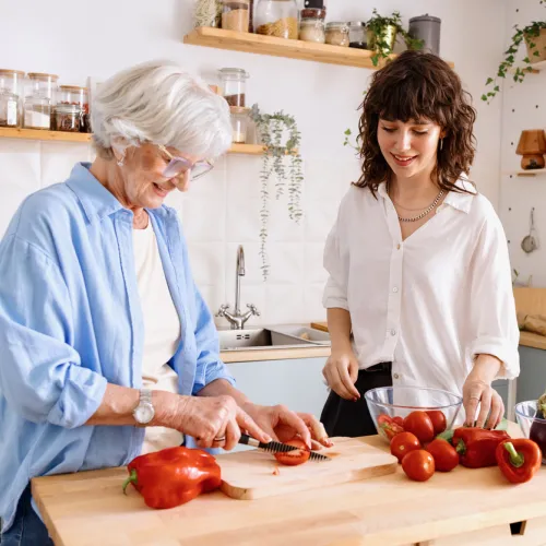 Two women preparing food in the kitchen