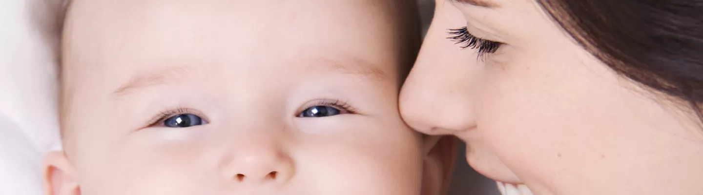 A woman smiling at a baby