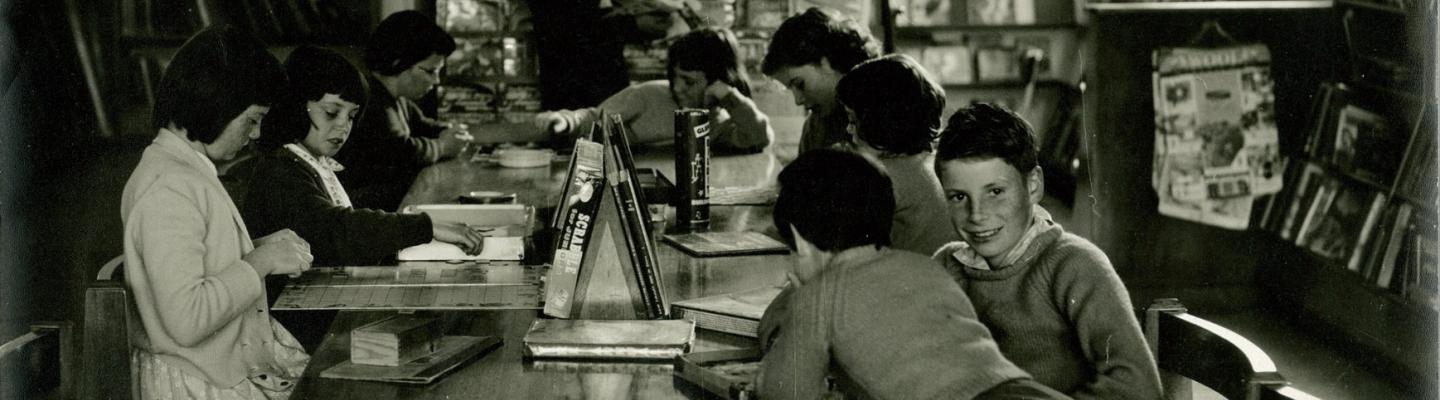 Black and white image of children playing board games