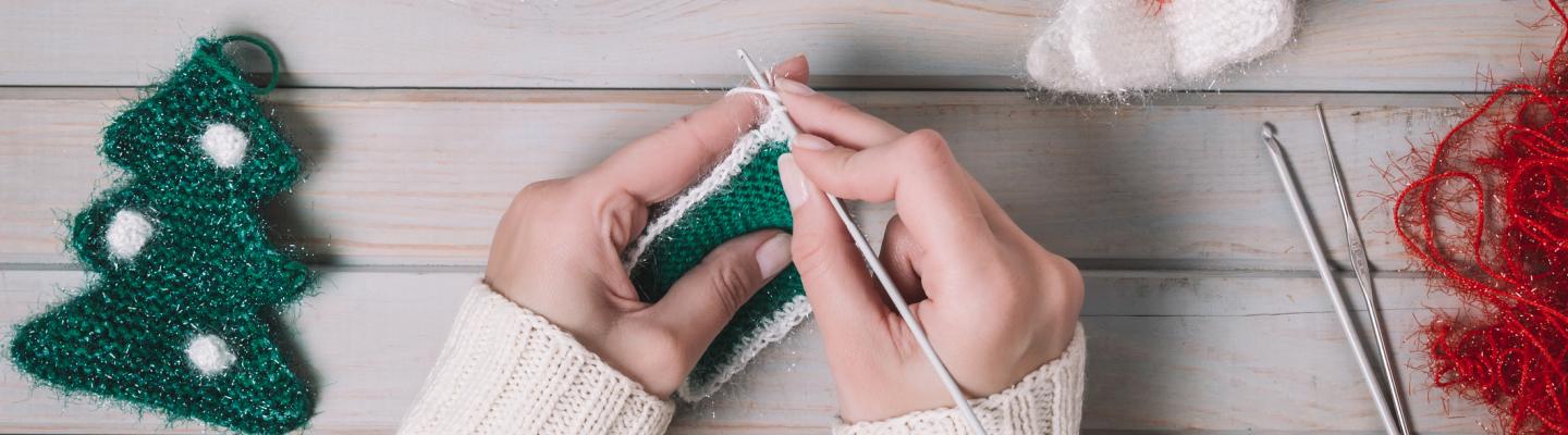 Hands crocheting with Christmas yarn 