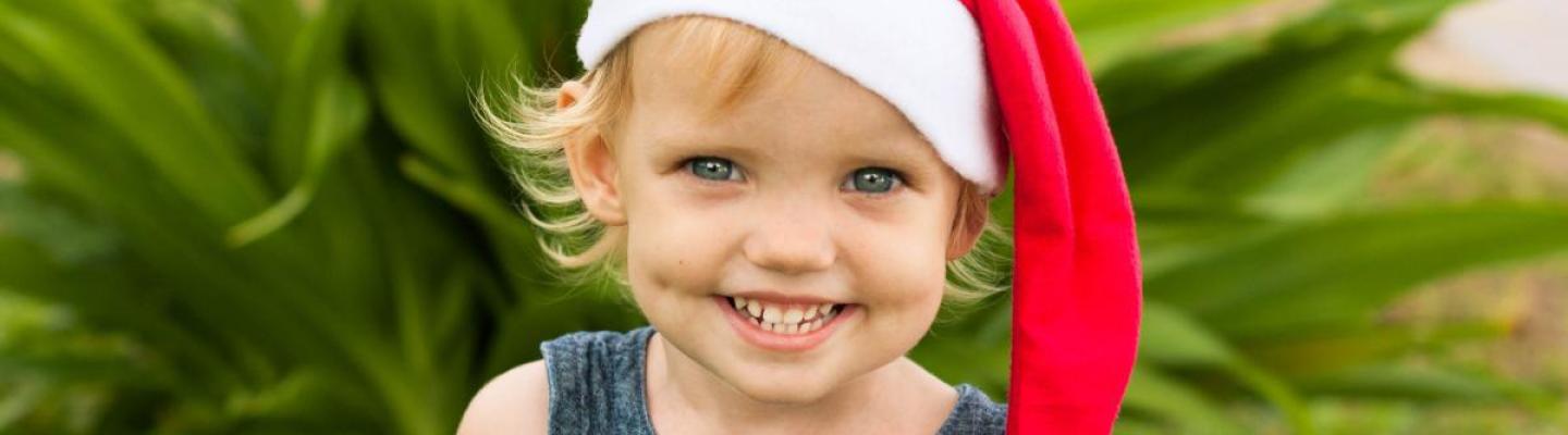 Young child wearing santa hat