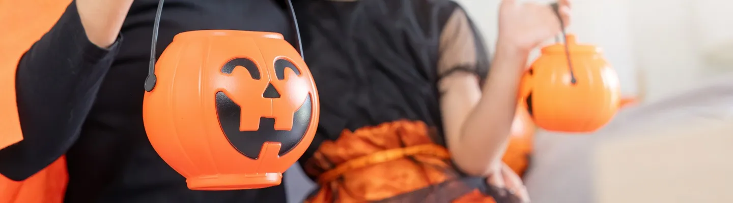 Someone holding pumpkin halloween lanters