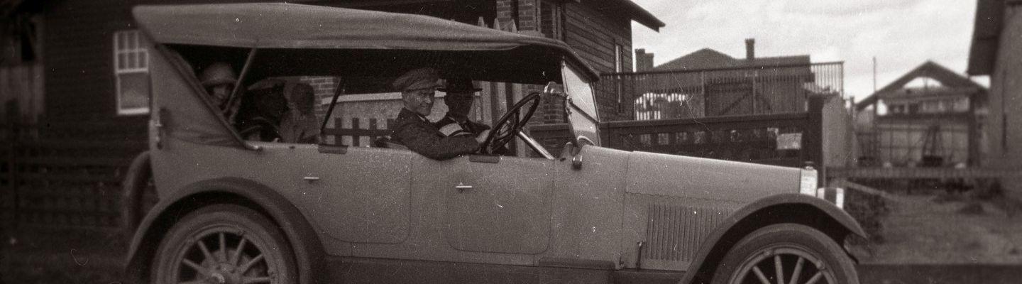 An old photo of a person in a car