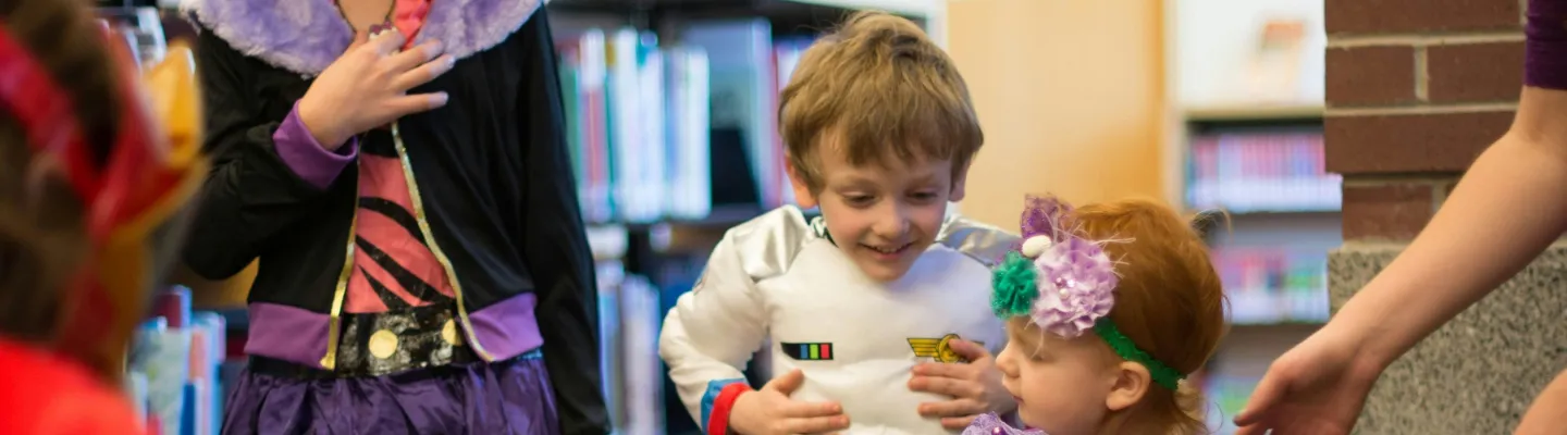Children in costumes at the library