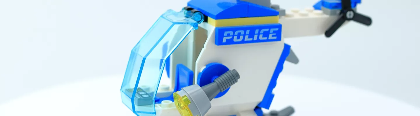 Lego constructed helicopter, white and blue in colour with police wording displayed on side