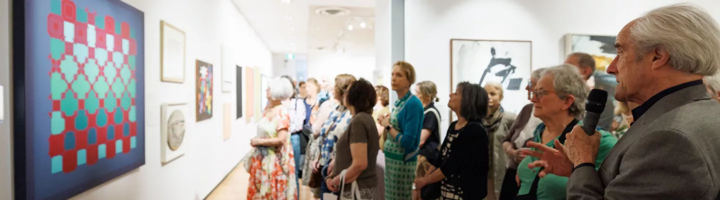 Group of people viewing art in gallery 