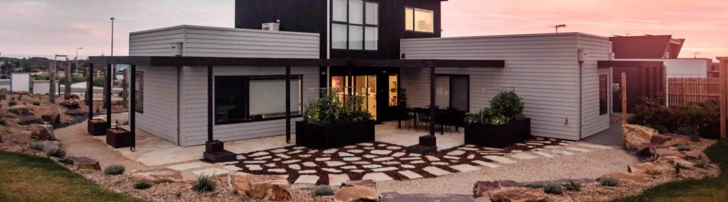 A house made of sustainable building materials and a stone landscaped garden