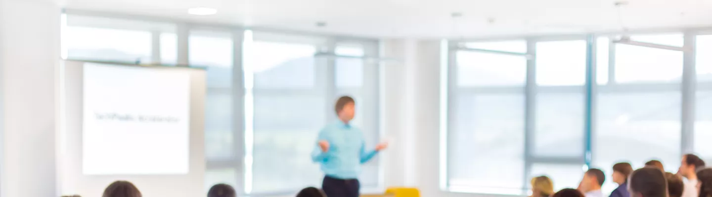 Person leading an informative session with an engaged audience.