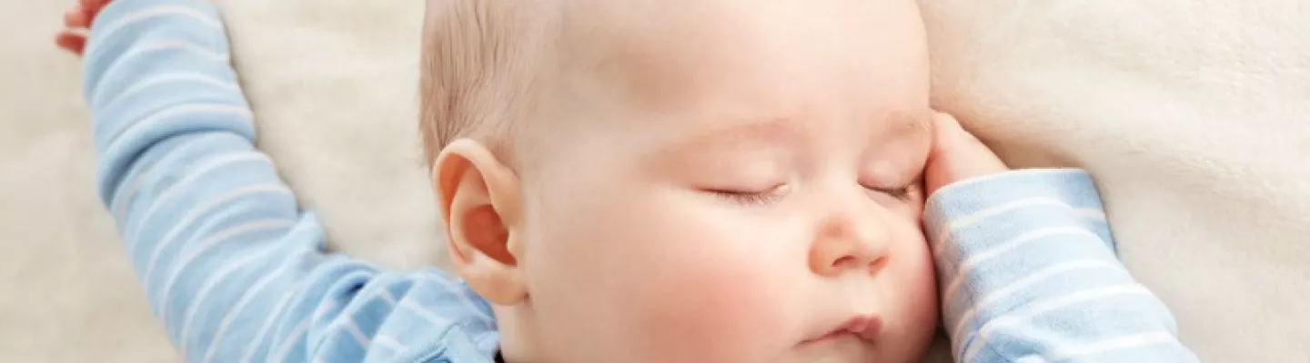 Sleeping baby in blue and white striped top