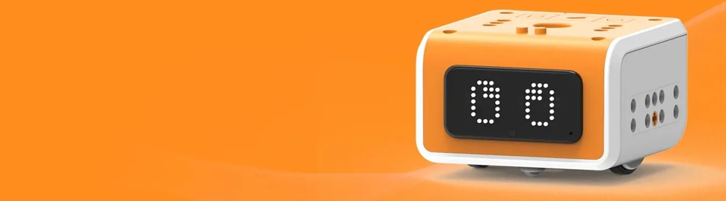 A vincibot, shaped like a rectangular cube is white in colour with a black square and eyes sits in an orange background.