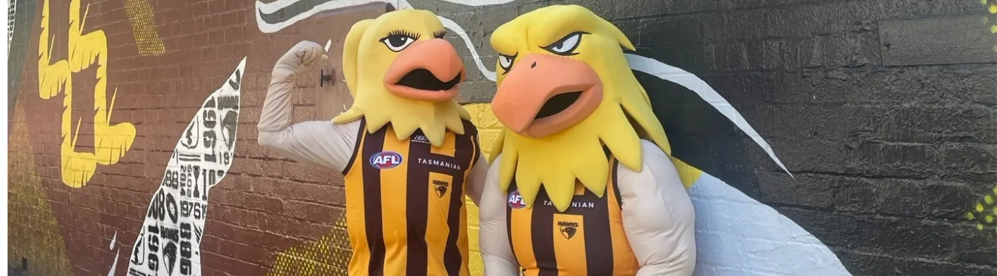 Two life-size yellow and brown hawk puppets