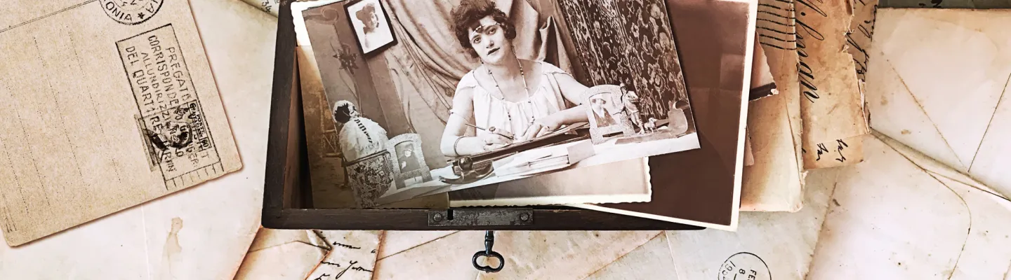 wooden box filled with black and white photographs and postcards