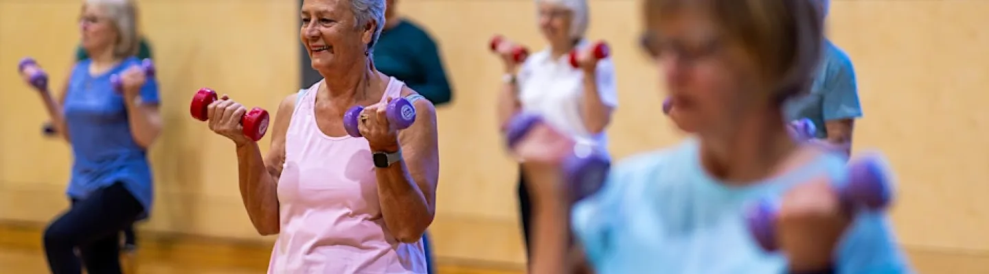 A group of women exercising with dumbells