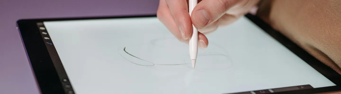 Person using a stylus pen on a tablet