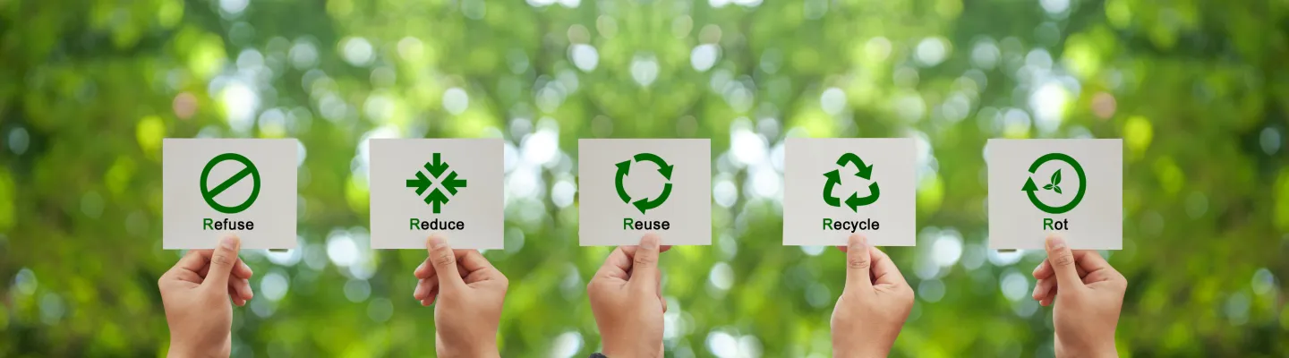 hands holding up signs saying refuse, reduce, reuse, recycle and rot.