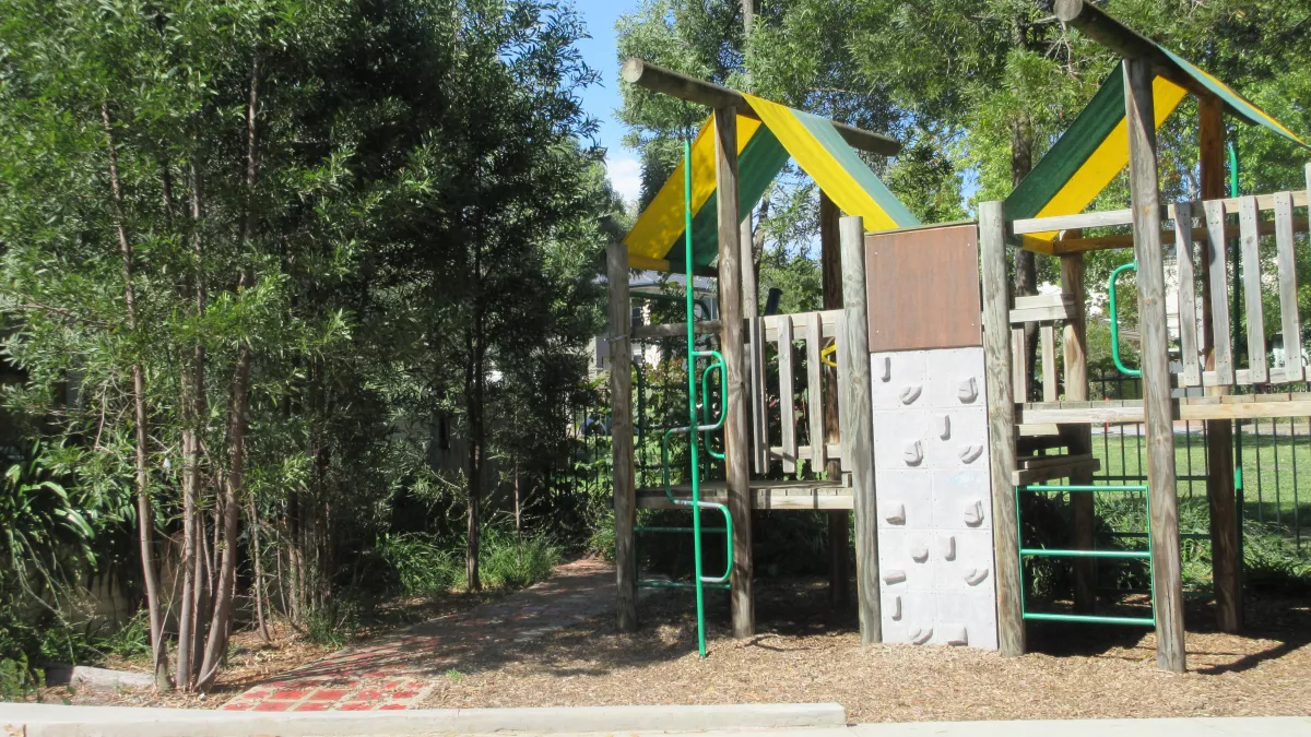 A climbing wall and play equipment at Yongala Preschool