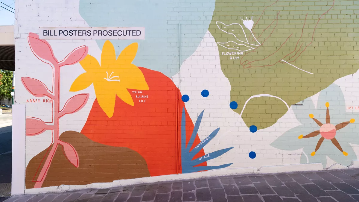 Detail of the mural, featuring a yellow bulbine lily, kangaroo grass and flowering gum.