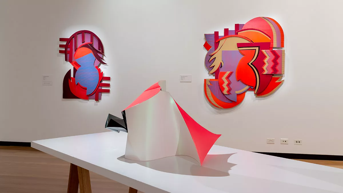 Installation view of 'Light Gestures' at Town Hall Gallery. Abstract geometric painting on the wall. Abstract sculptures on a table, made up of large flat surfaces and lots of angles.