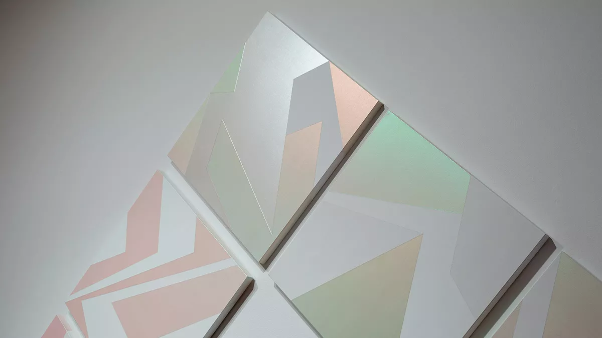 Detail of painting in 'Light Gestures: Samara Adamson- Pinczewski'. Made up of multiple small square canvas' turned to stand on their points. Painting has sharp lines and angles zig-zagging across the canvas's.