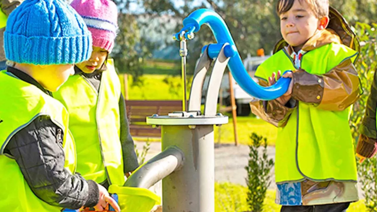 Kids wear hi-wis jackets play in the water play area