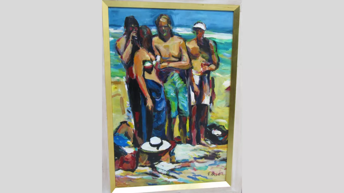 4 people in bathers standing on the beach.