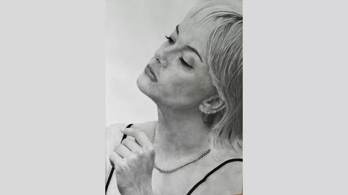 Woman with earrings along her ear, a nose ring and a chain necklace.