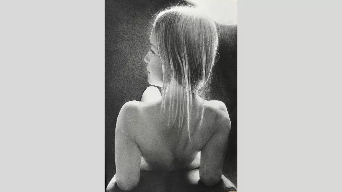 A girl's back as she reclines.