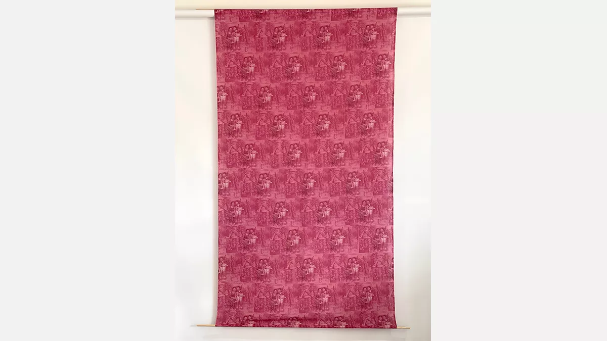 2 women and a small girl sitting together printed repeatedly across the fabric